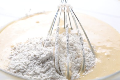 Photo of Whisk and bowl of dough, closeup view