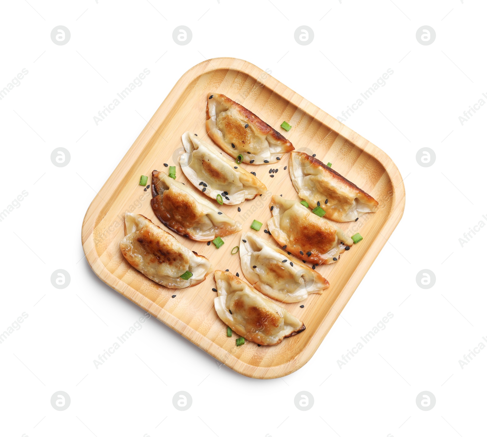 Photo of Delicious fried gyoza dumplings with green onions and sesame seeds isolated on white, top view