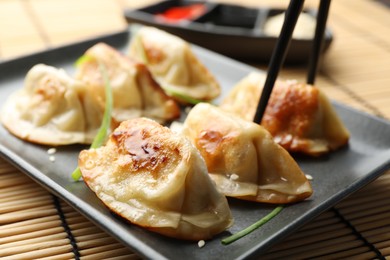 Photo of Delicious fried gyoza dumplings on table, closeup