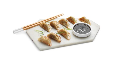 Delicious fried gyoza dumplings with sesame seeds, microgreens and soy sauce isolated on white