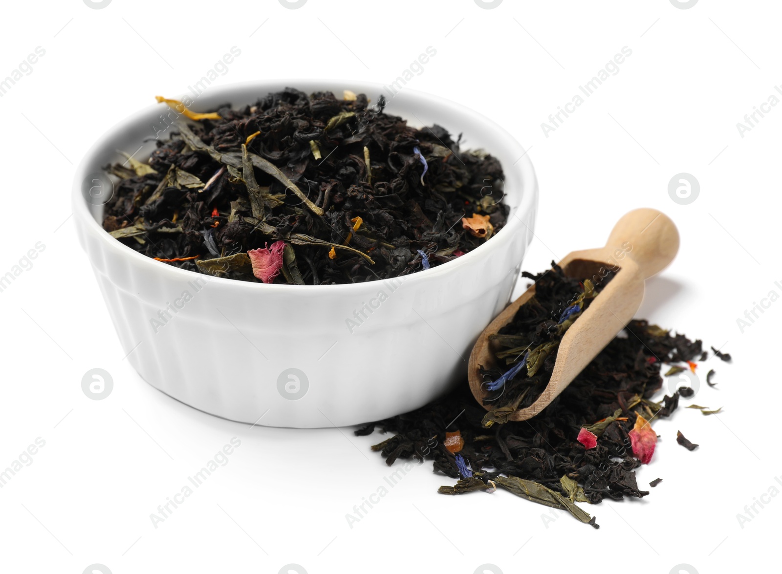 Photo of Dry tea leaves in bowl and scoop isolated on white