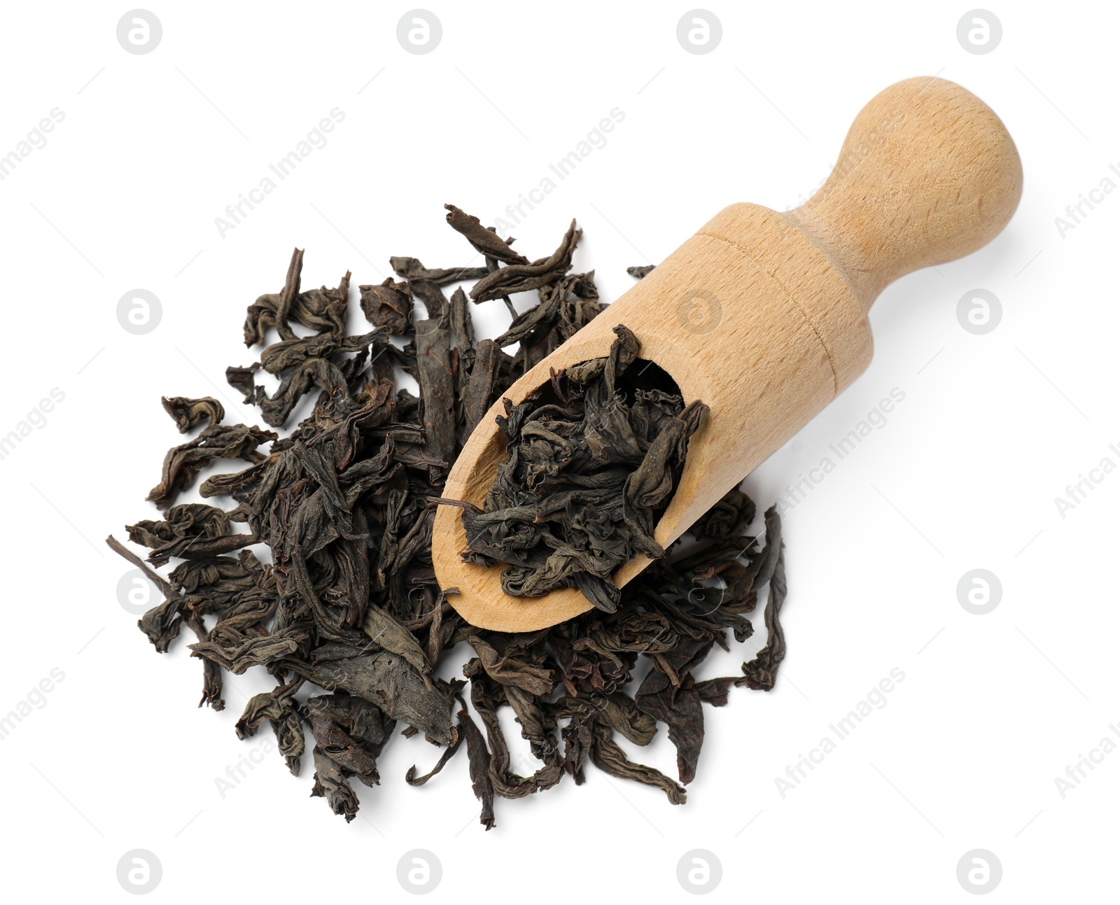 Photo of Dry tea leaves and wooden scoop isolated on white, top view