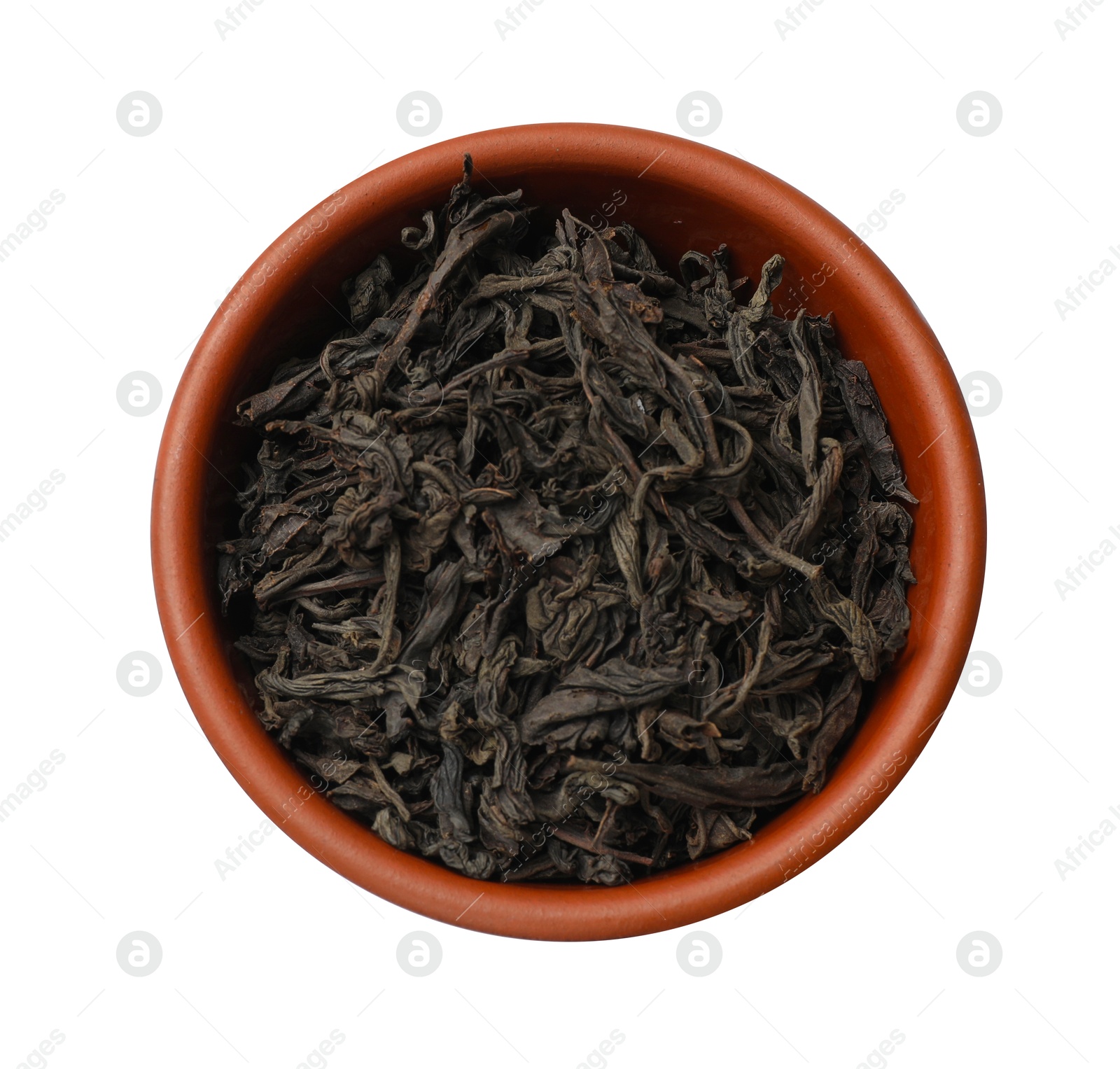 Photo of Dry tea leaves in bowl isolated on white, top view