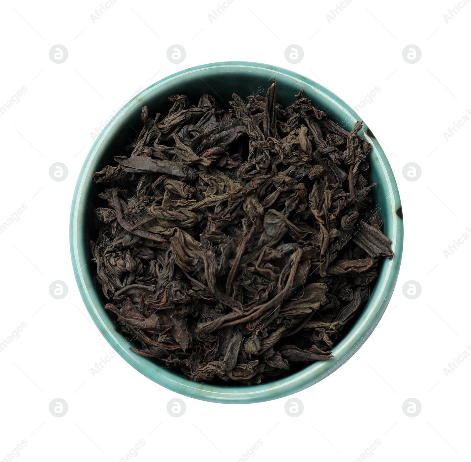 Photo of Dry tea leaves in bowl isolated on white, top view