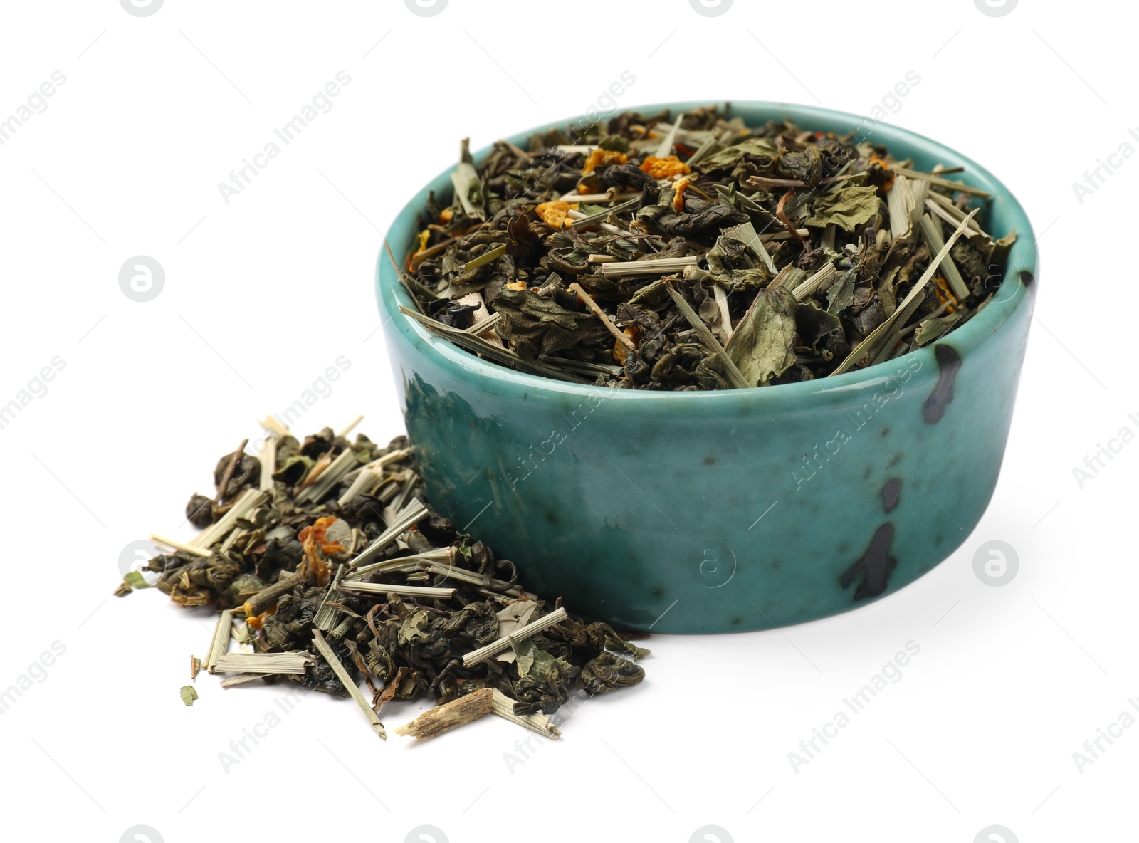 Photo of Dry tea leaves in bowl isolated on white