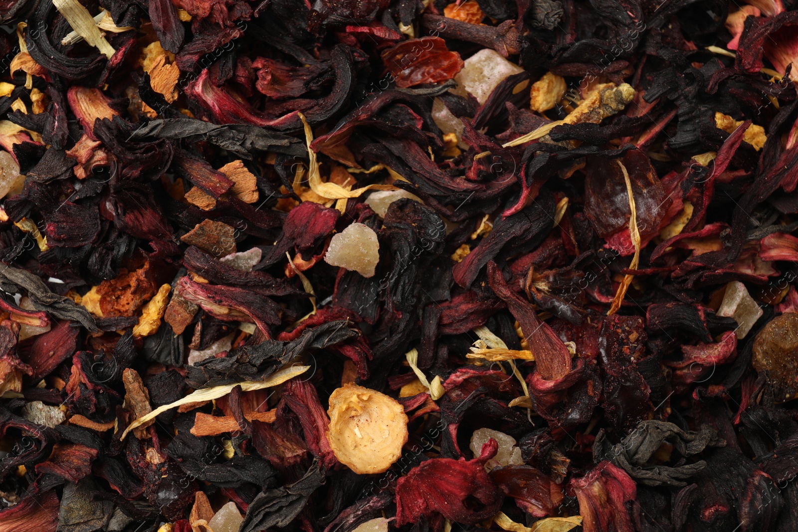 Photo of Aromatic dried tea leaves as background, closeup