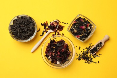 Photo of Different types of tea brew on yellow background, flat lay