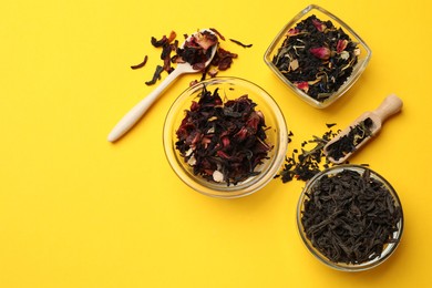 Photo of Different types of tea brew on yellow background, flat lay. Space for text