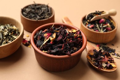 Photo of Different types of tea brew on brown background, closeup