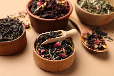 Photo of Different types of tea brew on brown background, closeup