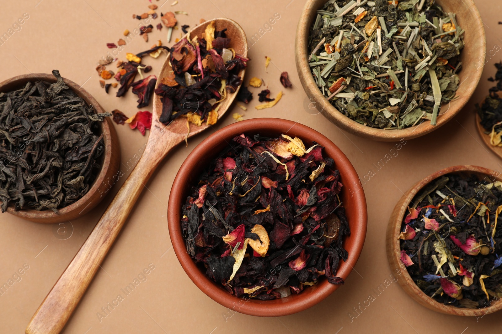 Photo of Different types of tea brew on brown background, flat lay