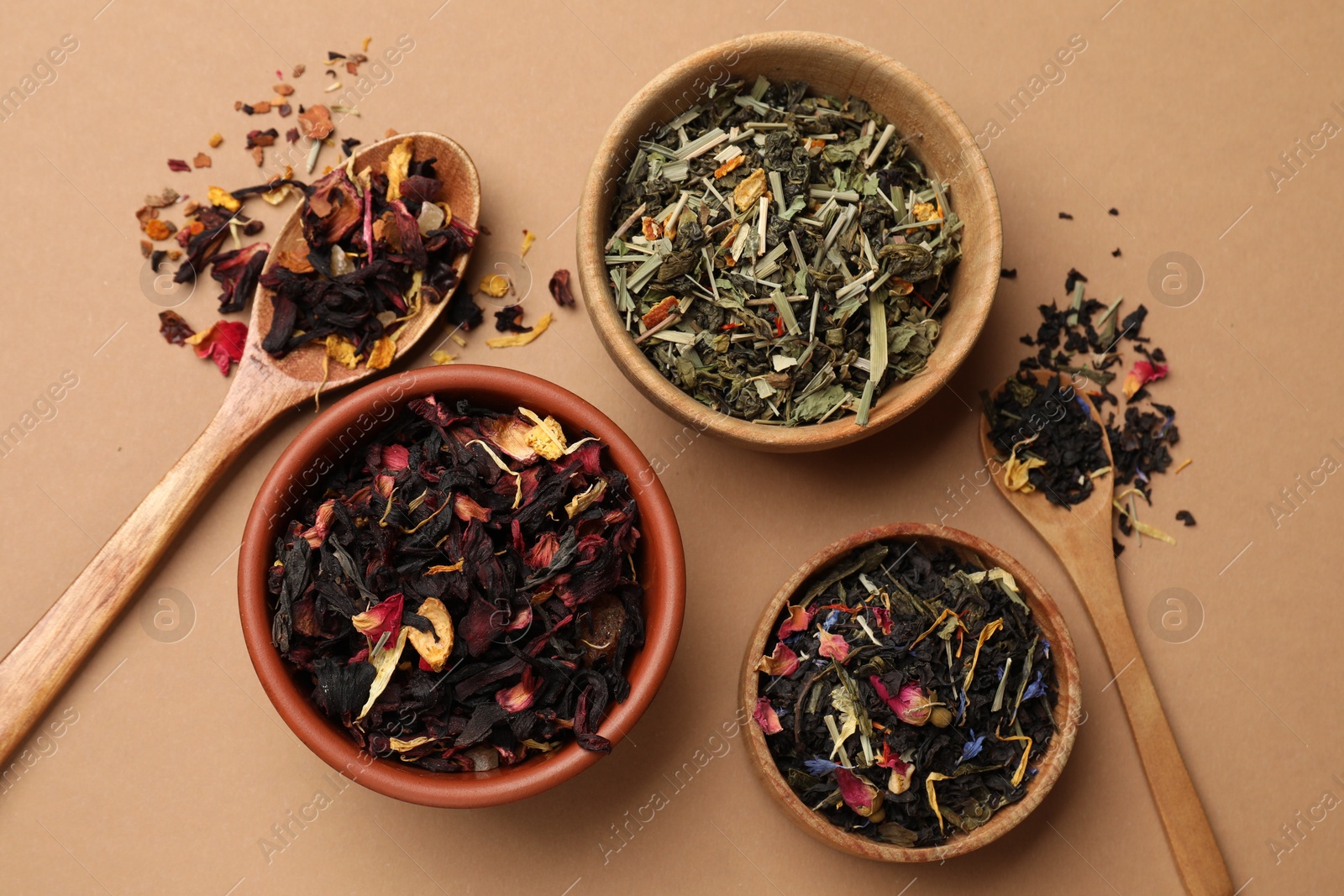 Photo of Different types of tea brew on brown background, flat lay