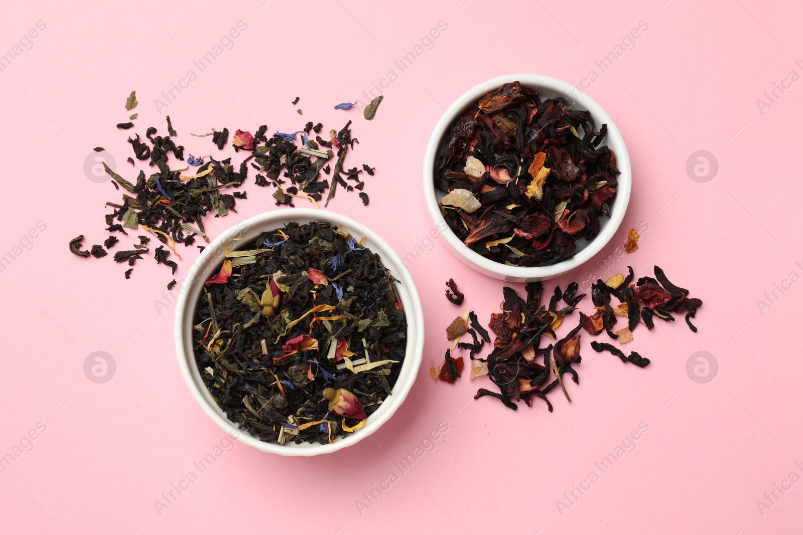 Photo of Different types of tea brew on light pink background, flat lay