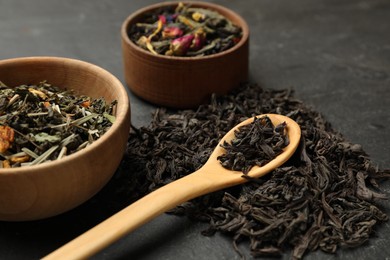 Photo of Different types of tea brew on black table, closeup