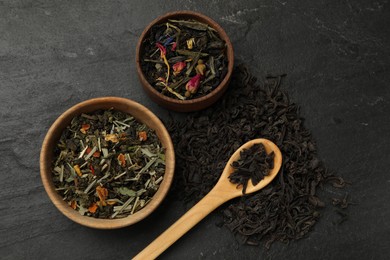 Photo of Different types of tea brew on black table, flat lay