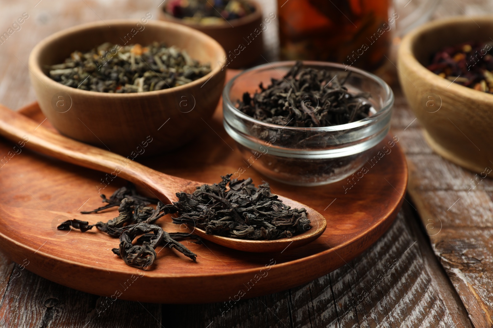 Photo of Different types of tea brew on wooden table, closeup