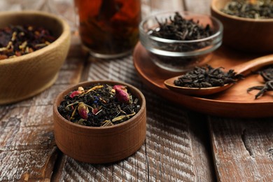 Photo of Different types of tea brew on wooden table, closeup