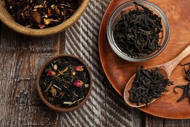 Photo of Different types of tea brew on wooden table, flat lay