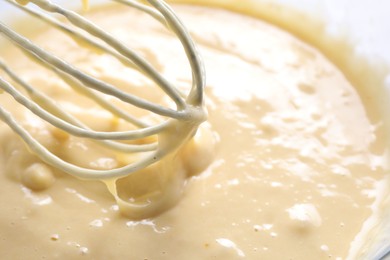 Photo of Whisk and bowl of dough, closeup view