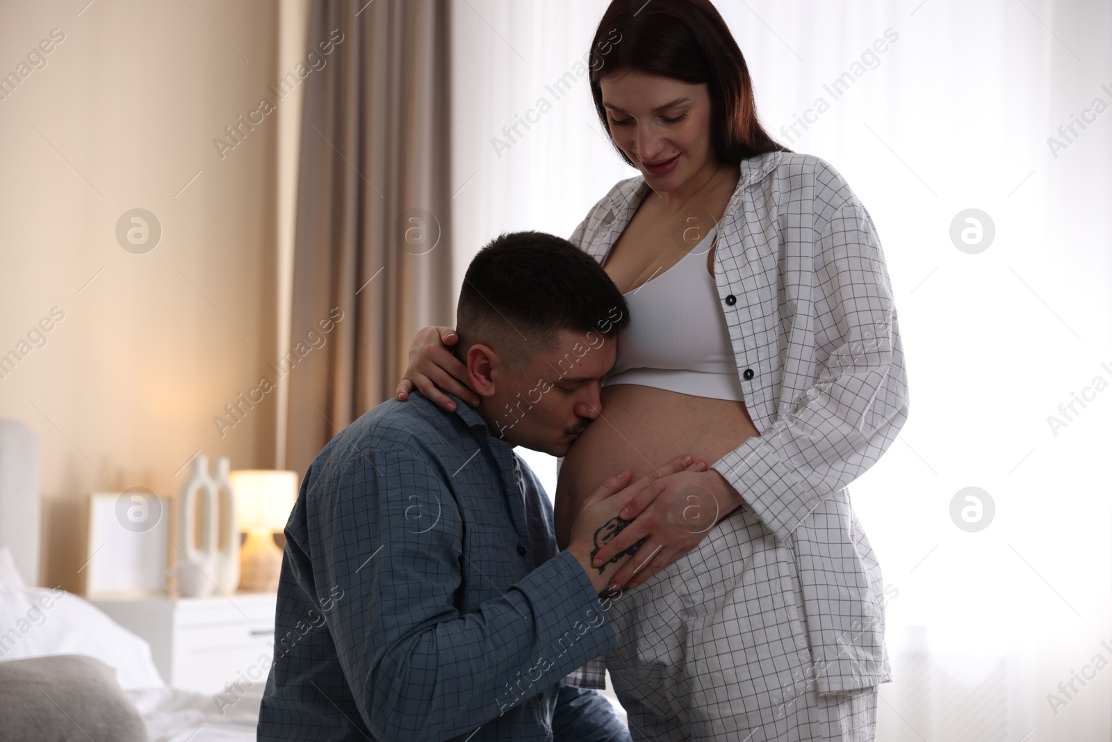 Photo of Pregnant woman and her husband at home