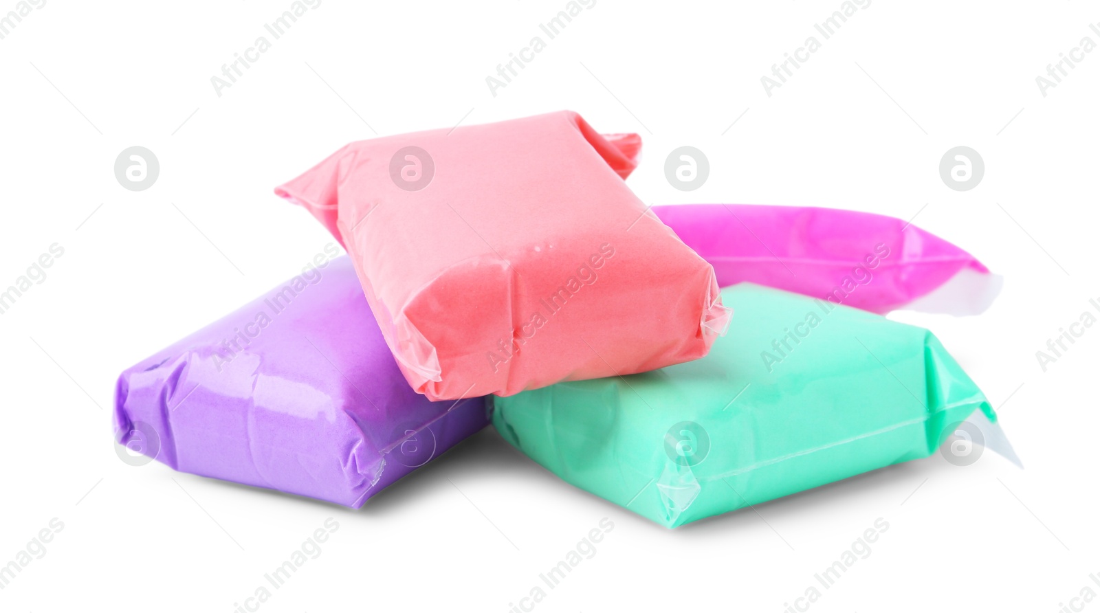 Photo of Different colorful play dough in packages isolated on white