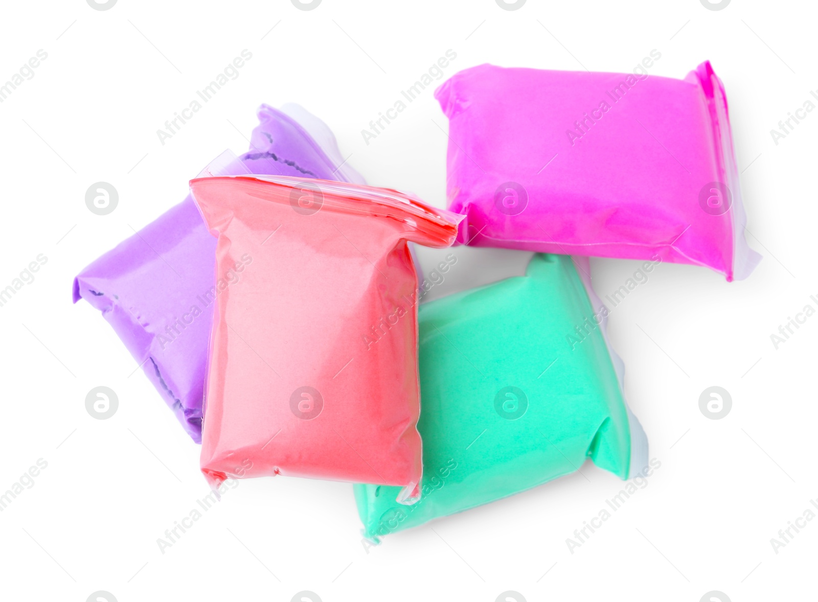 Photo of Different colorful play dough in packages isolated on white, top view