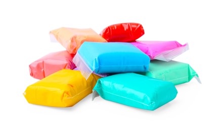 Photo of Different colorful play dough in packages isolated on white