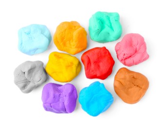 Photo of Different colorful play dough on white background, flat lay