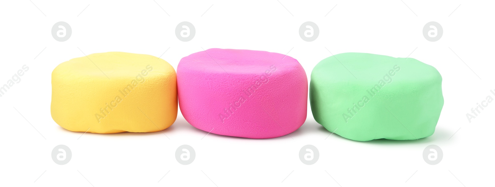 Photo of Different colorful play dough isolated on white