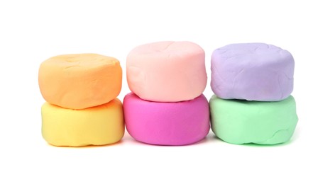 Photo of Different colorful play dough isolated on white