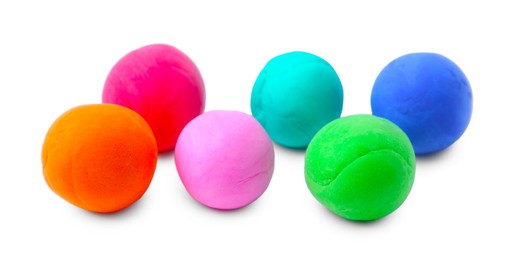 Photo of Different colorful play dough balls isolated on white