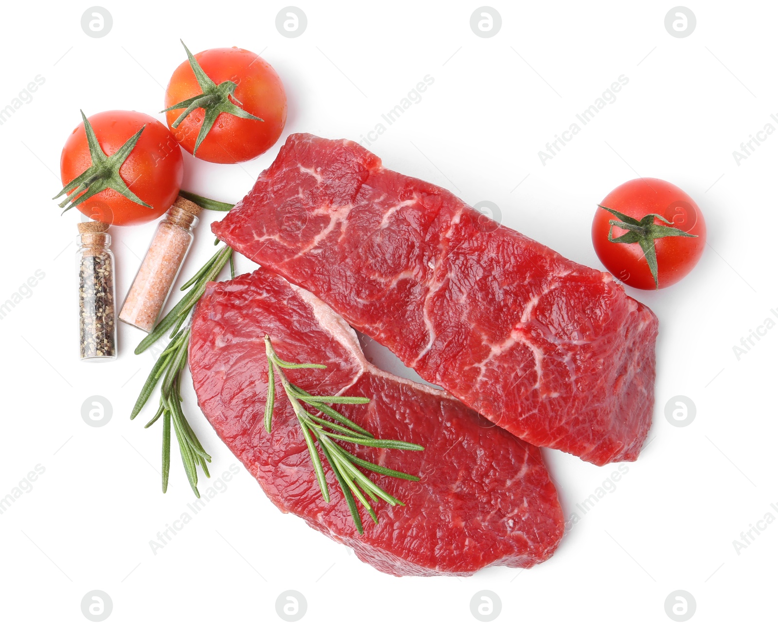 Photo of Pieces of raw beef meat, spices and tomatoes isolated on white, top view