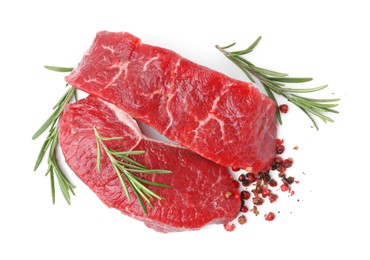 Photo of Pieces of raw beef meat and spices isolated on white, top view