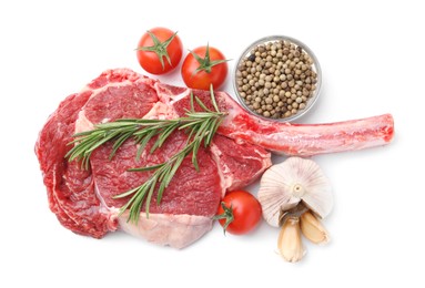 Photo of Piece of raw beef meat, spices and tomatoes isolated on white, top view