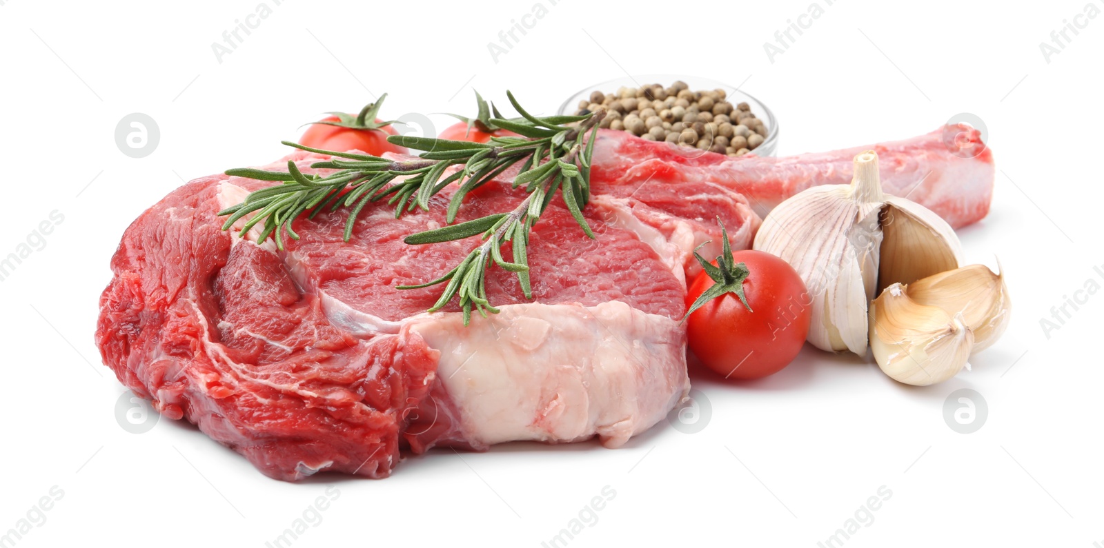 Photo of Piece of raw beef meat, spices and tomatoes isolated on white