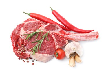 Photo of Piece of raw beef meat, spices and tomato isolated on white, top view