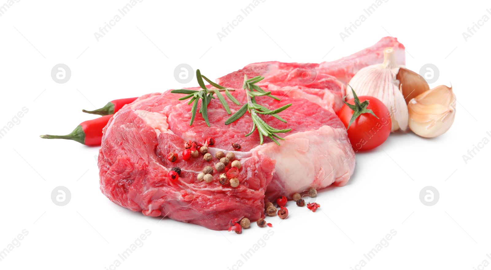 Photo of Piece of raw beef meat, spices and tomato isolated on white