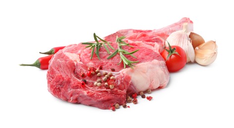 Photo of Piece of raw beef meat, spices and tomato isolated on white