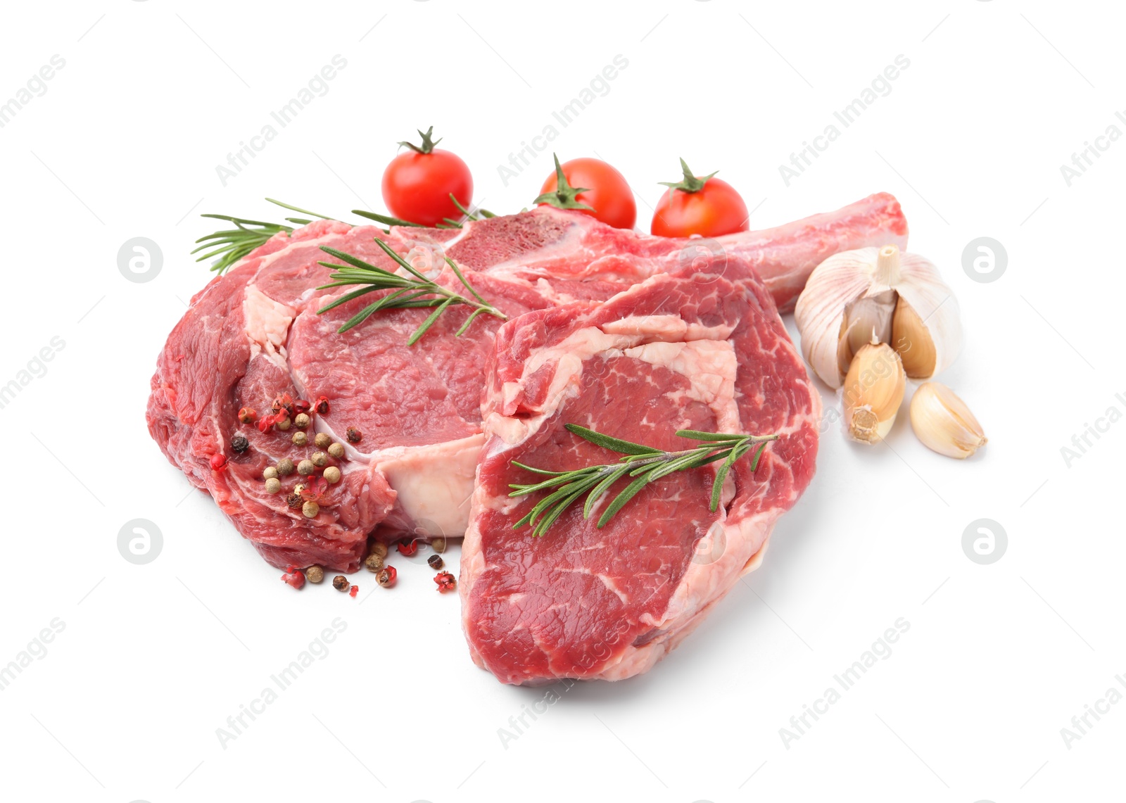 Photo of Pieces of raw beef meat, spices and tomatoes isolated on white