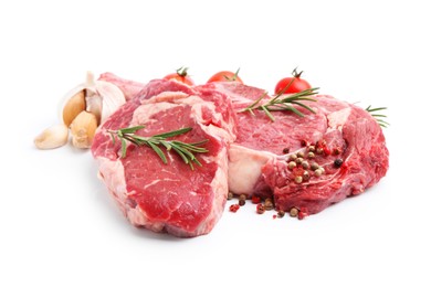 Photo of Pieces of raw beef meat, spices and tomatoes isolated on white