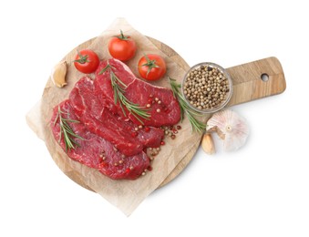 Photo of Pieces of raw beef meat, spices and tomatoes isolated on white, top view