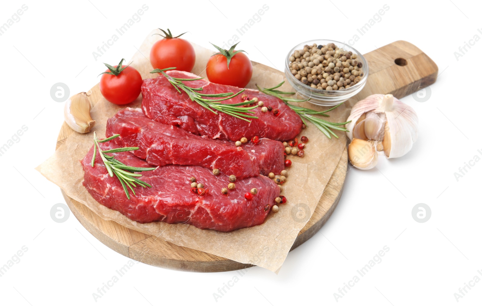 Photo of Pieces of raw beef meat, spices and tomatoes isolated on white