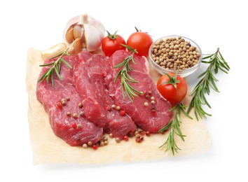 Photo of Pieces of raw beef meat, spices and tomatoes isolated on white