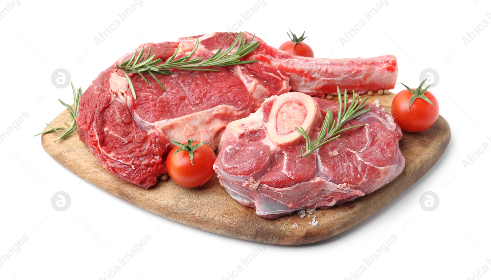 Photo of Pieces of raw beef meat, spices and tomatoes isolated on white