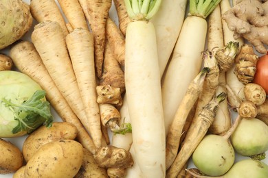 Photo of Many different root vegetables as background, top view