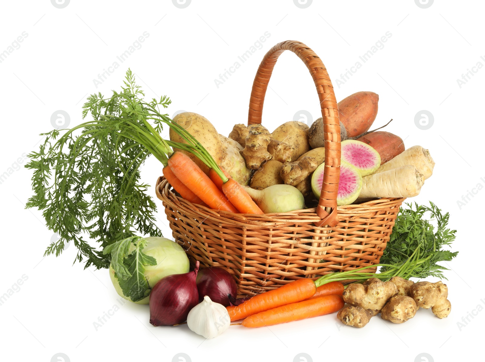 Photo of Different root vegetables in wicker basket isolated on white