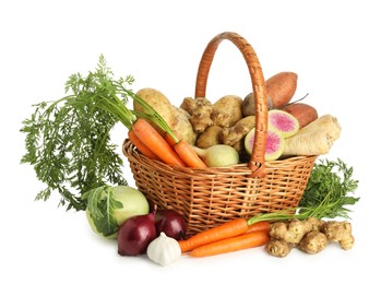 Different root vegetables in wicker basket isolated on white