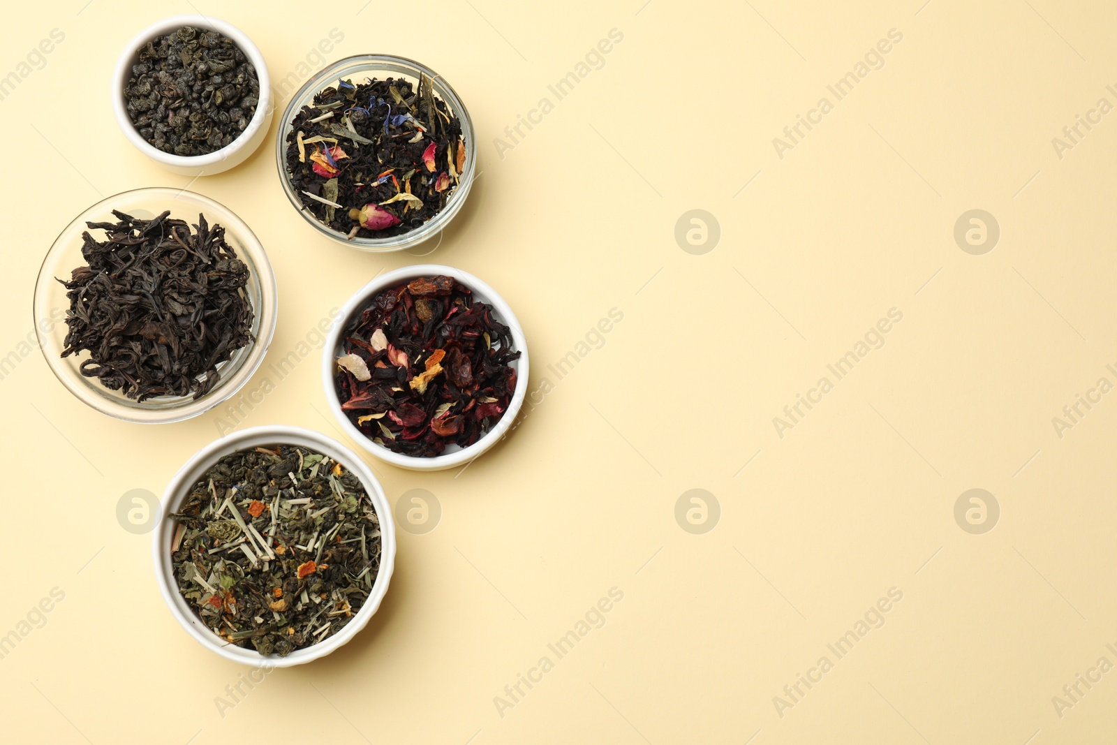 Photo of Different types of tea brew on beige background, flat lay. Space for text