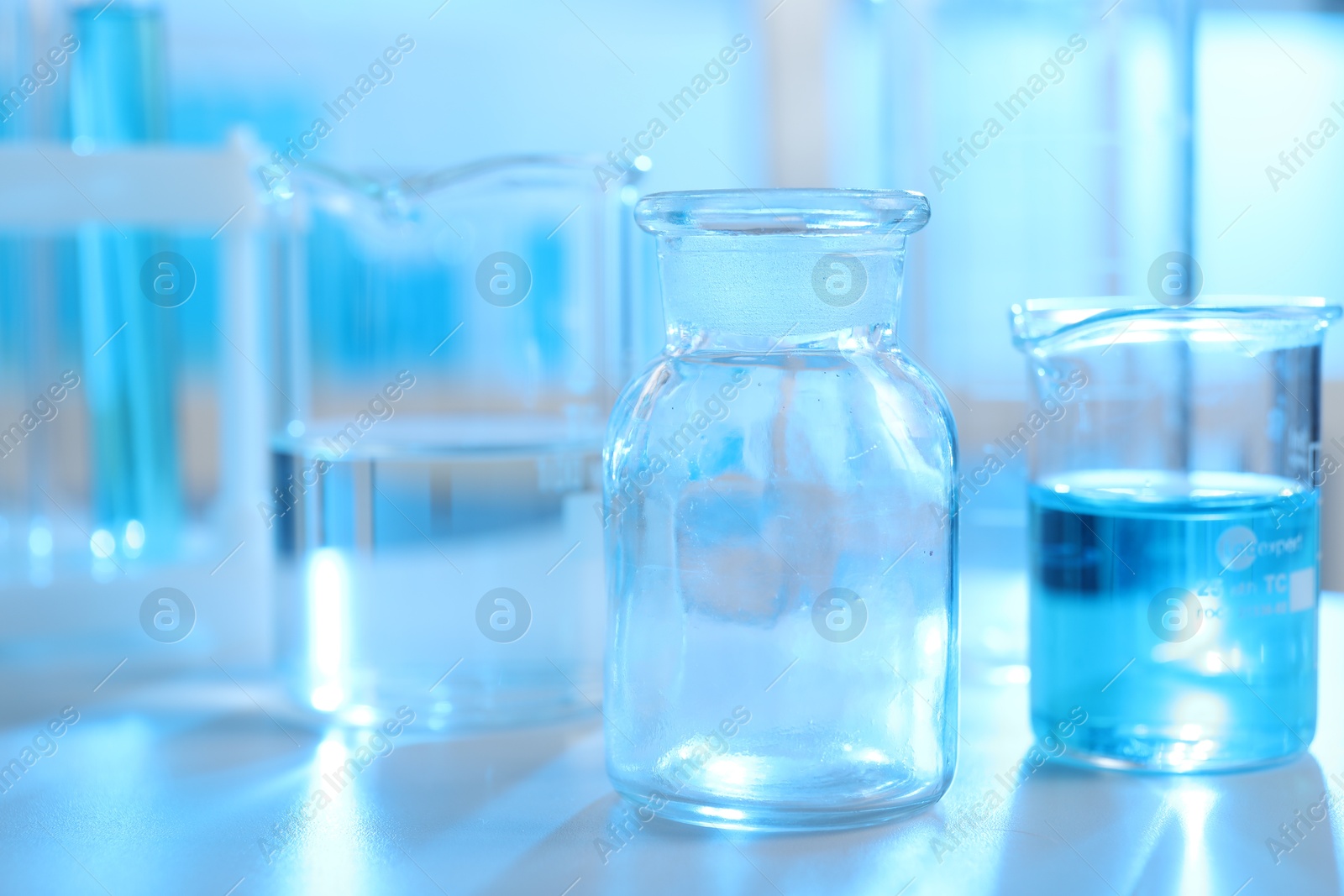 Photo of Laboratory glassware with liquid on table indoors