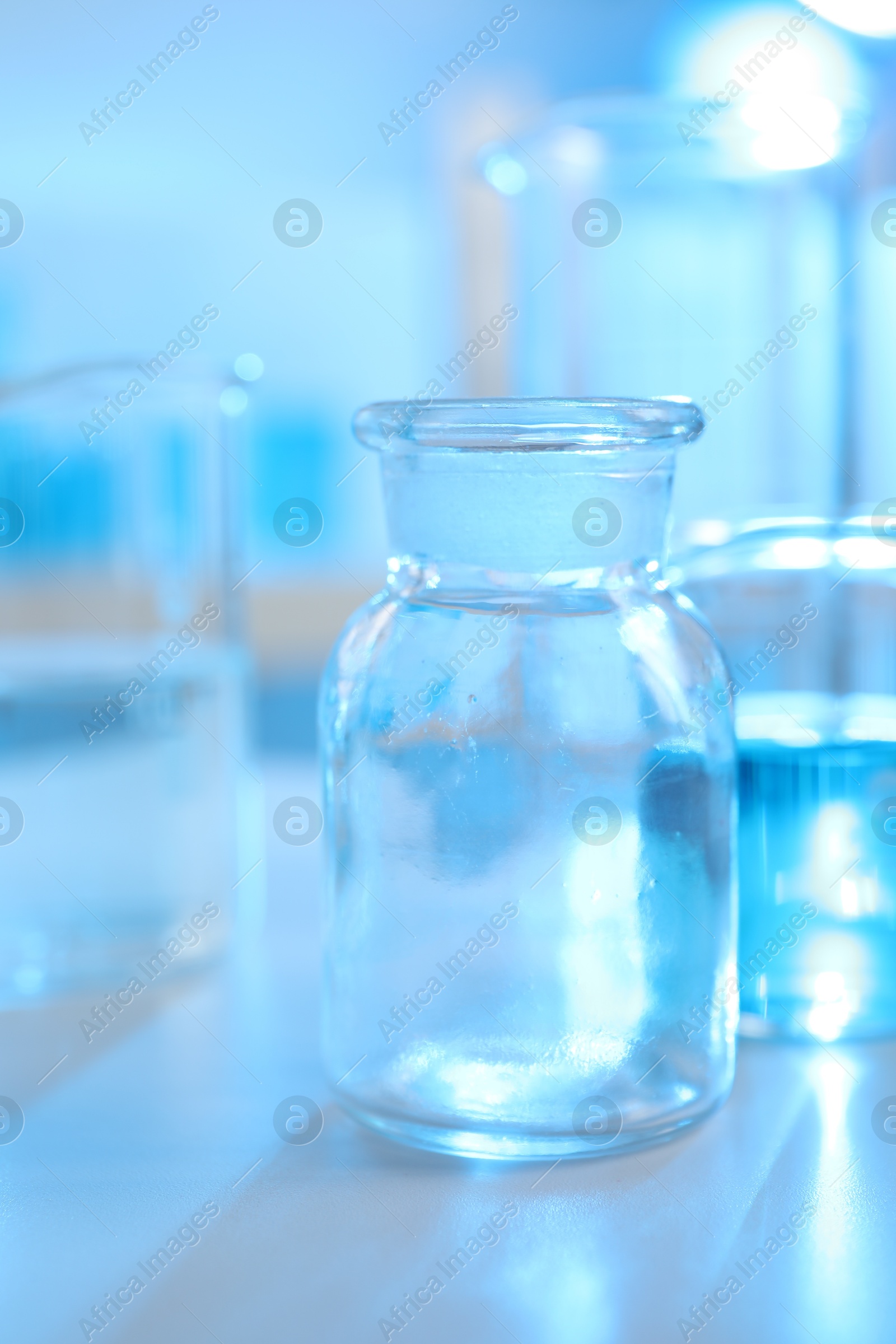 Photo of Laboratory glassware with liquid on table indoors